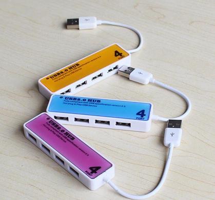 Three different color rectangular shaped USB hubs on a table