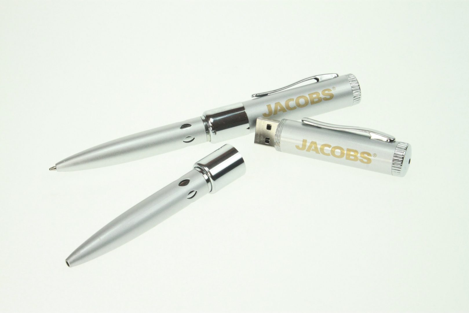 Two Jacobs pens with USB drive on plain with background