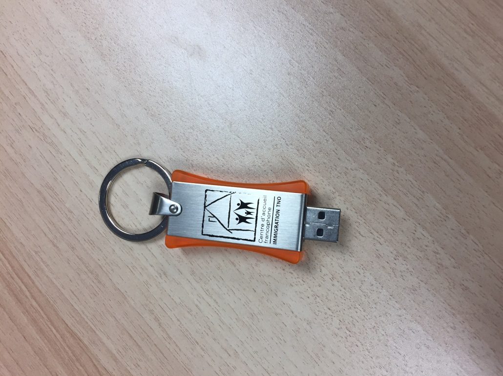 Orange and Stainless Steel Key Chain On Desk
