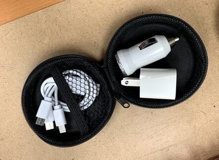 An open Travel Charging Kit with accessories