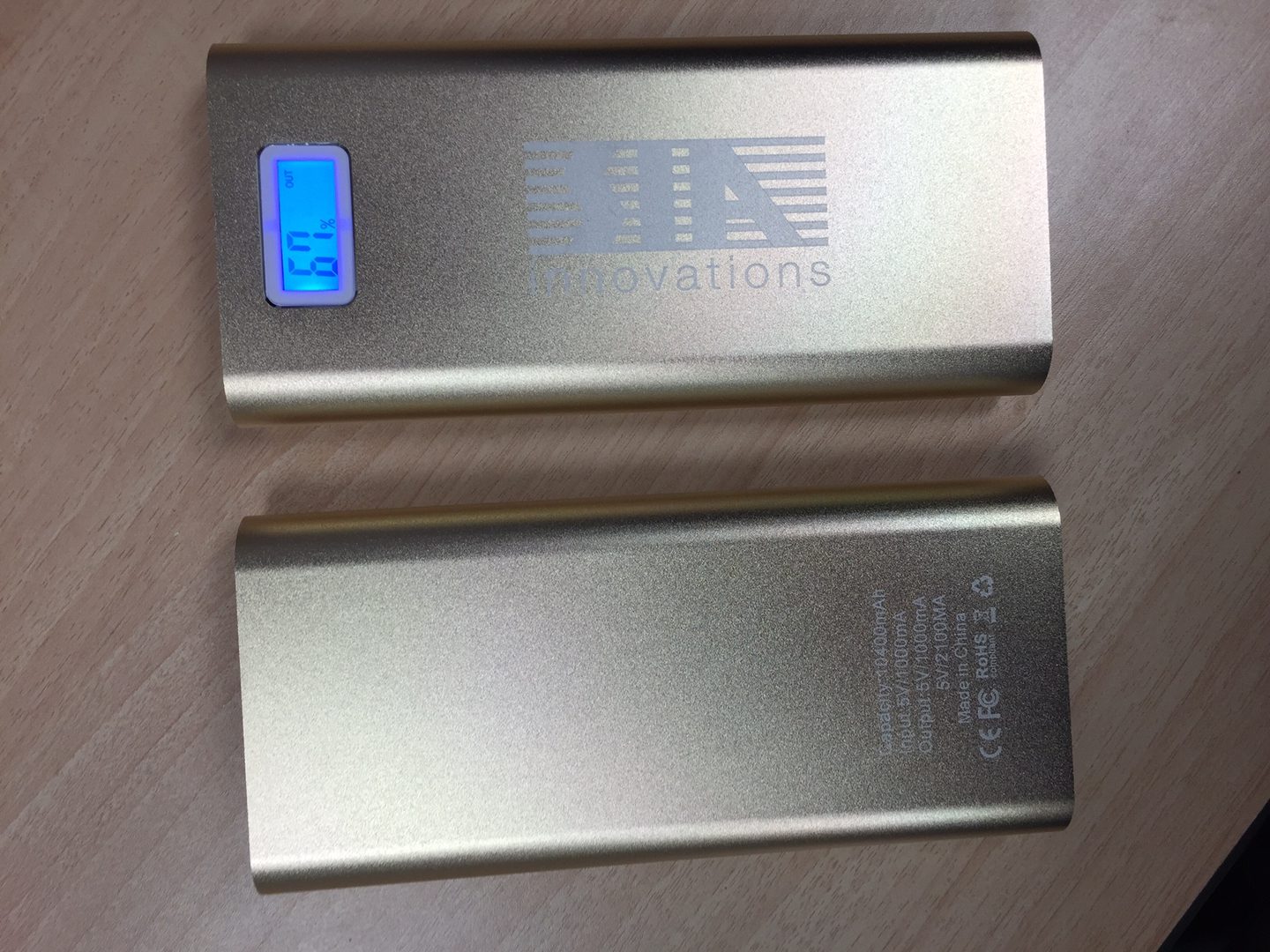 A Silver Color Power Bank With a Blue Display