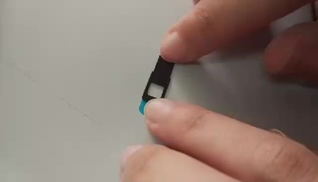 A Hand Opening a Webcam Cover