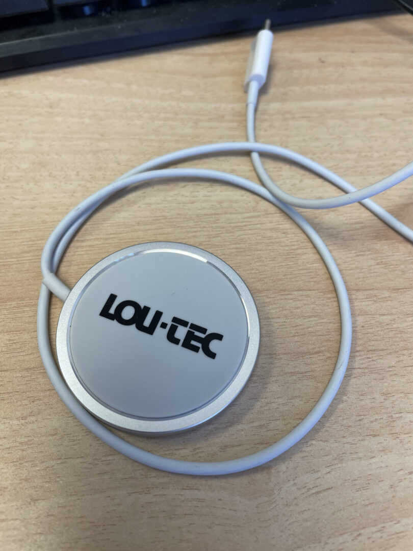 A gray color wireless charger kept on a desk