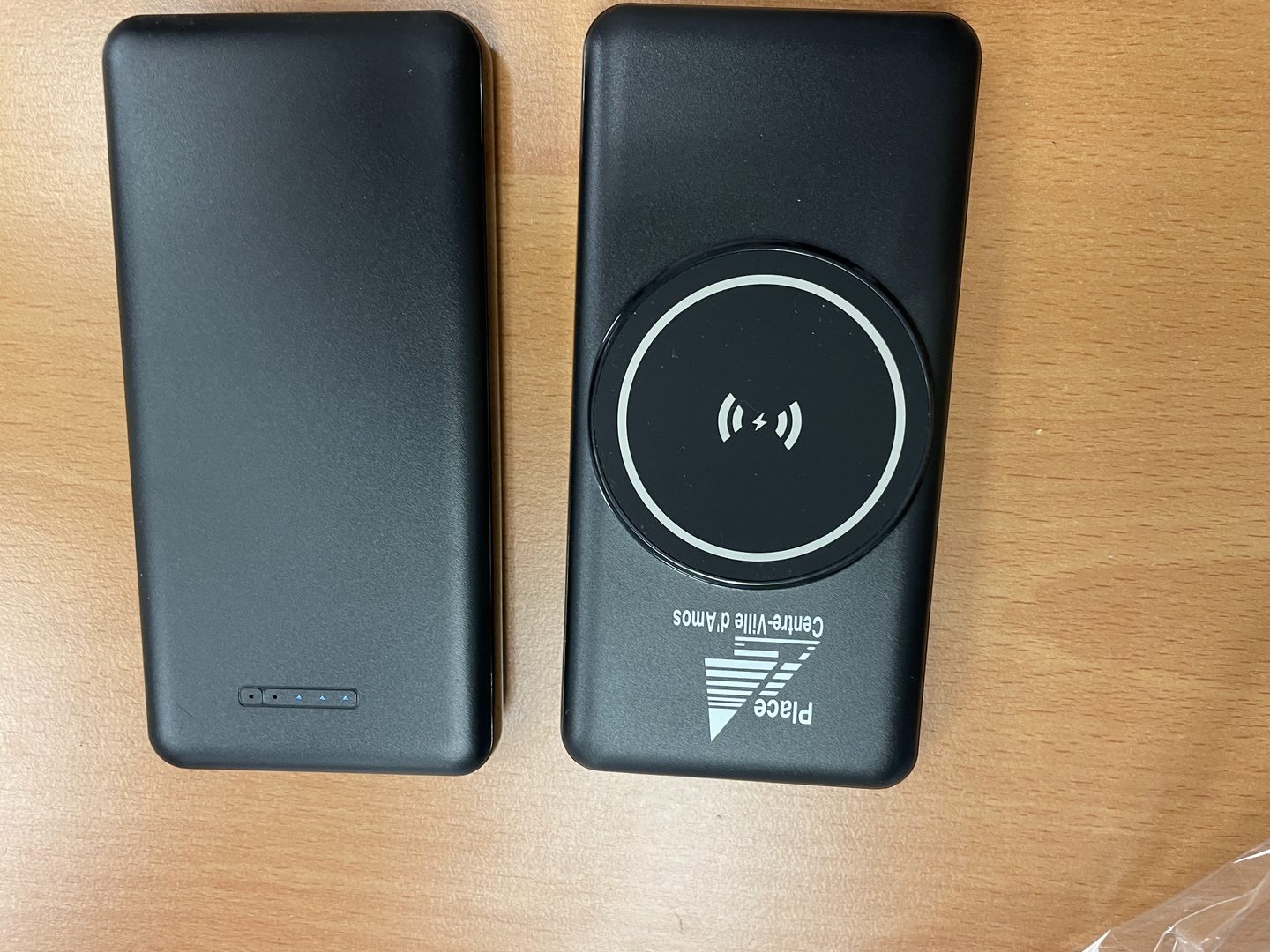 Two Black Wireless Power Bank placed in the desk