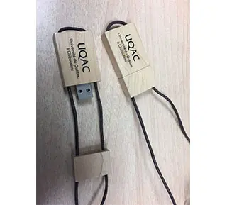 Two wooden USB drives with black threads
