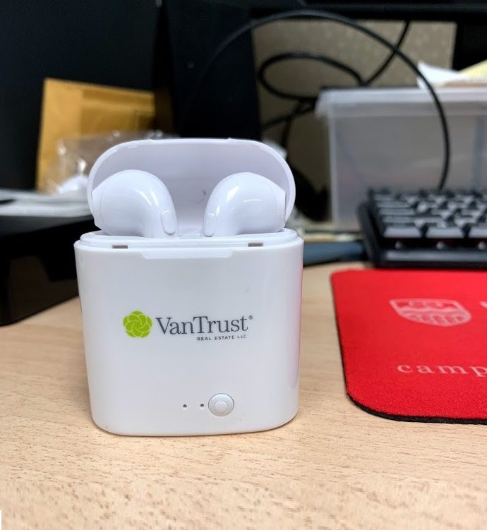 A white color van trust labeled AirPods on a table
